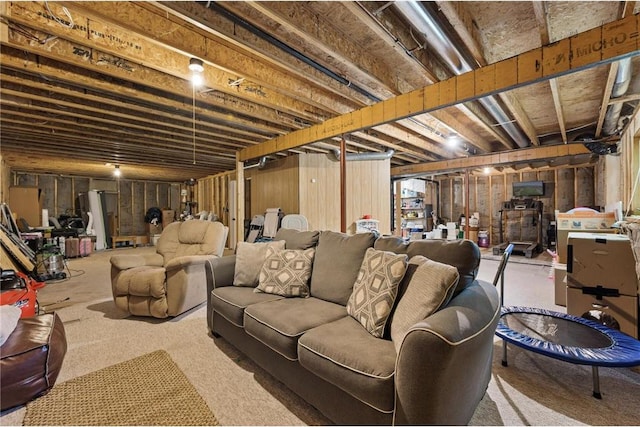 unfinished basement with freestanding refrigerator