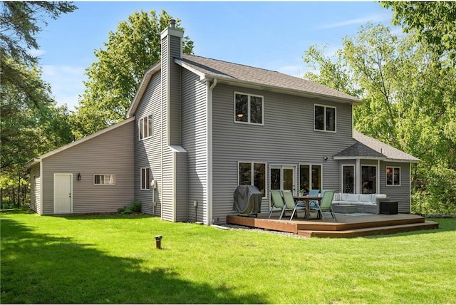 back of property featuring a lawn, a deck, outdoor lounge area, a shingled roof, and a chimney