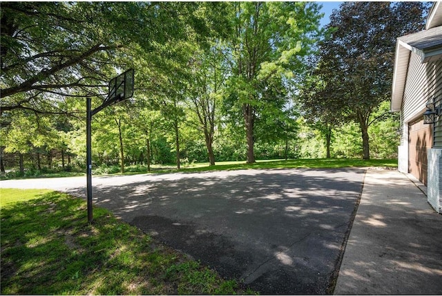 view of basketball court featuring a yard