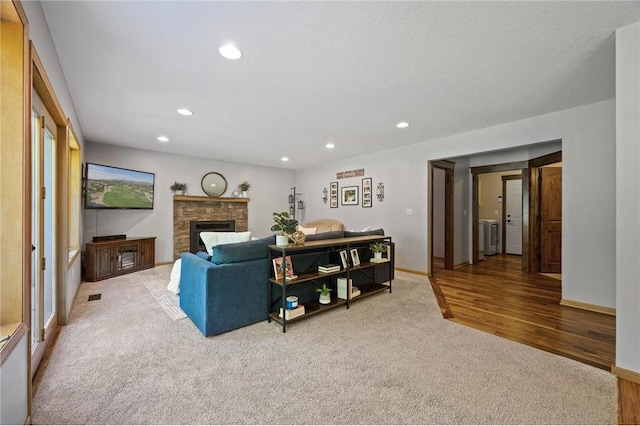 living area featuring carpet flooring, recessed lighting, a fireplace, and baseboards