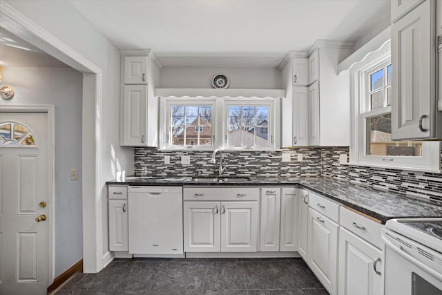 kitchen with white cabinetry, decorative backsplash, white dishwasher, and a sink