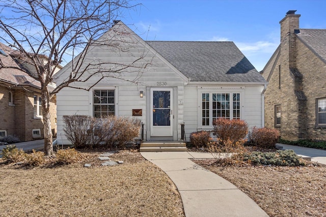 bungalow-style home featuring a shingled roof