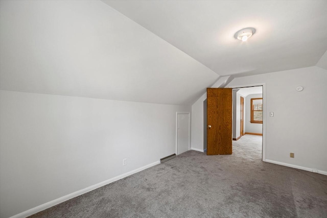 additional living space featuring lofted ceiling, baseboards, and carpet floors