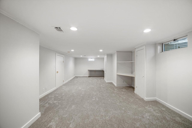 basement with visible vents, baseboards, and carpet flooring