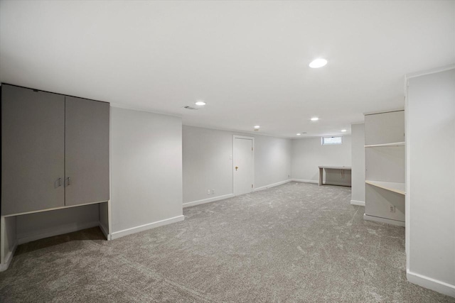 basement featuring recessed lighting, baseboards, and carpet