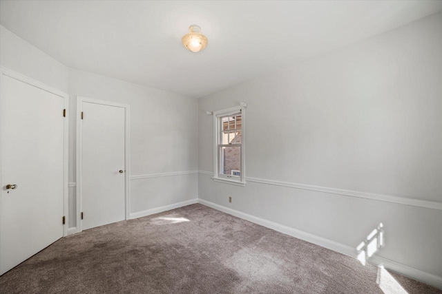 unfurnished room featuring baseboards and carpet floors