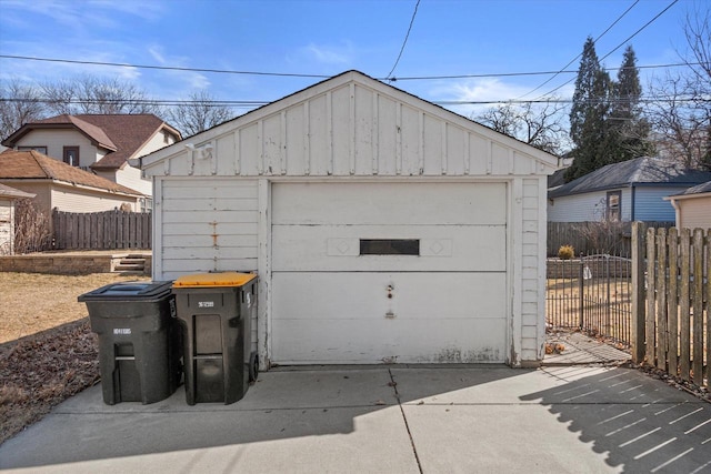 detached garage featuring fence