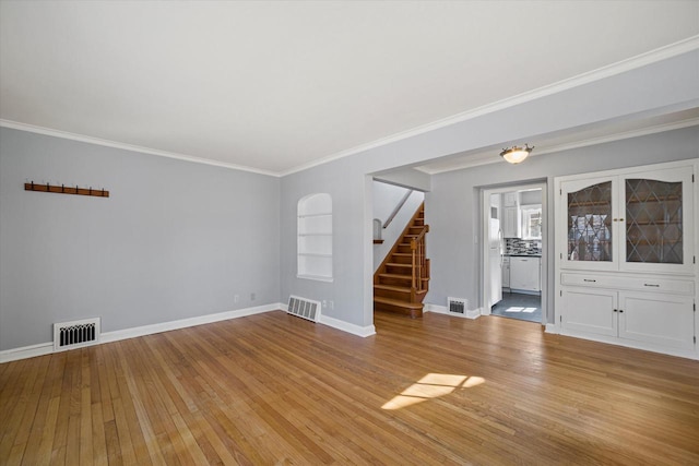 unfurnished living room featuring stairway, baseboards, visible vents, and light wood finished floors