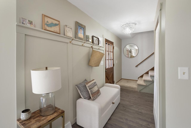 interior space with a notable chandelier and wood finished floors