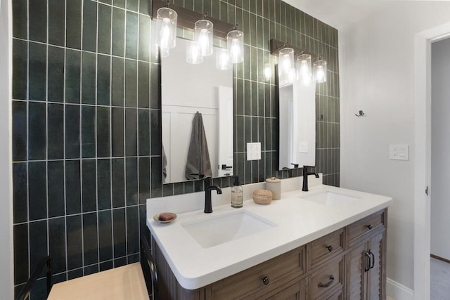 full bathroom with tile walls, double vanity, and a sink