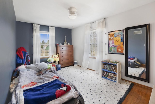 bedroom featuring baseboards and visible vents