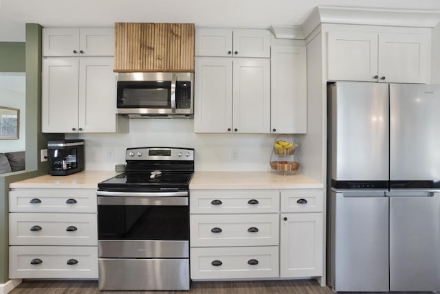 kitchen featuring white cabinetry, light countertops, dark wood finished floors, and appliances with stainless steel finishes