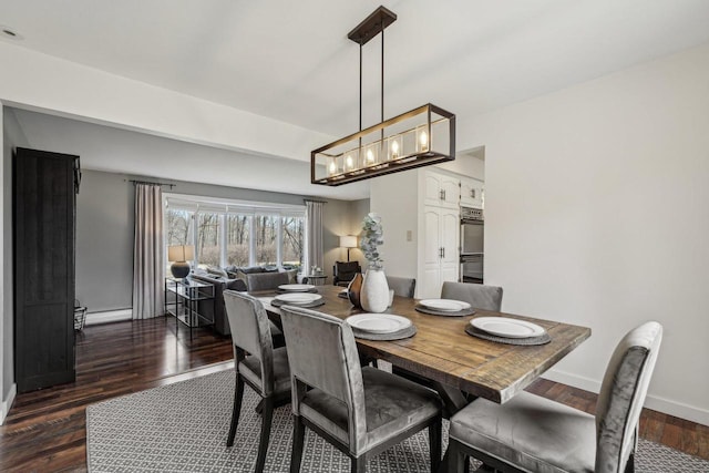 dining area with dark wood-style floors, an inviting chandelier, and baseboards