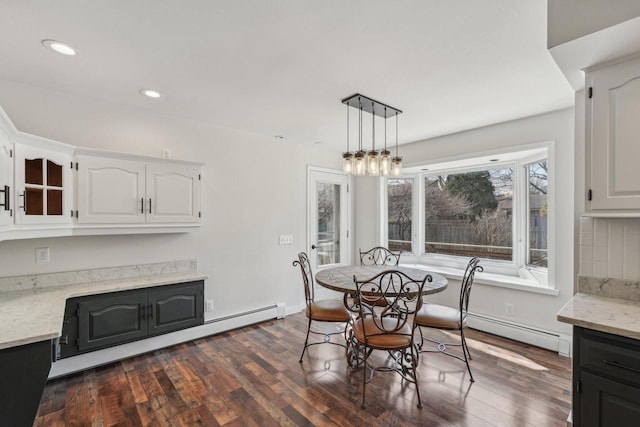 dining room with dark wood-style floors, recessed lighting, a baseboard heating unit, and baseboards