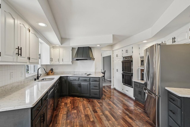 kitchen featuring backsplash, premium range hood, gray cabinets, black appliances, and a sink