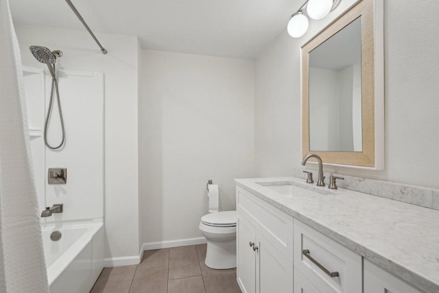 bathroom featuring vanity, baseboards, bathtub / shower combination, tile patterned floors, and toilet