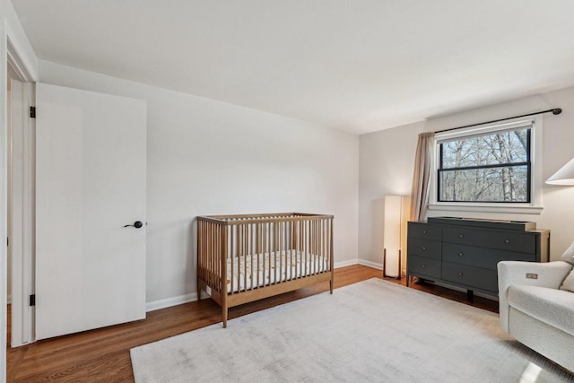 bedroom featuring baseboards and wood finished floors