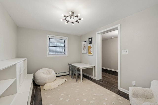 bedroom with a chandelier, baseboards, baseboard heating, and wood tiled floor