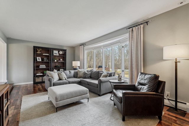 living room featuring wood finished floors, baseboards, and a baseboard radiator