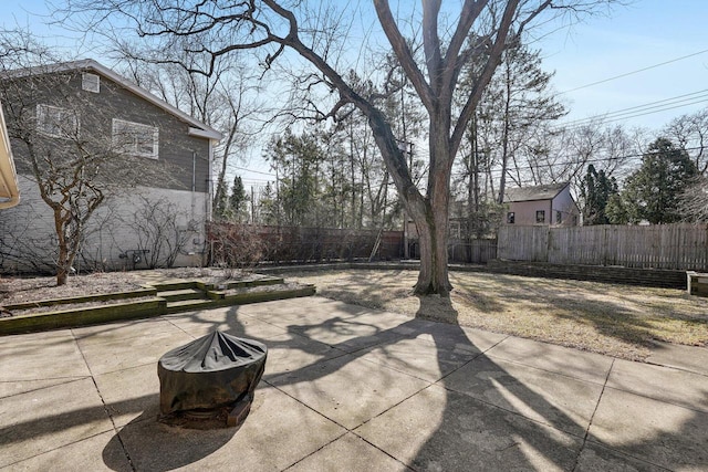 view of patio featuring an outdoor fire pit and a fenced backyard