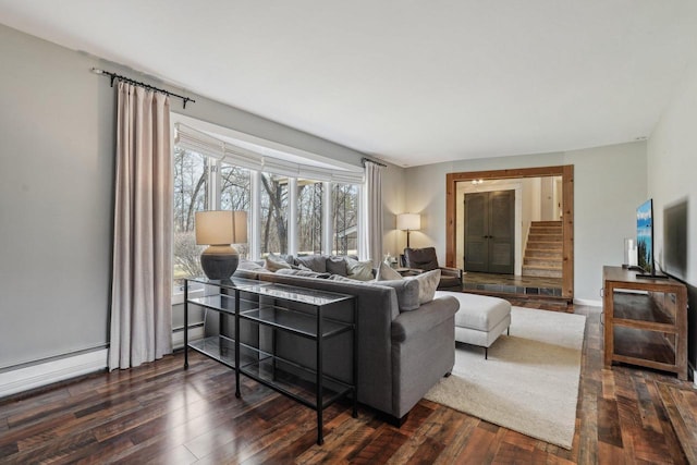 living room featuring stairway, baseboards, dark wood-style flooring, and a baseboard radiator