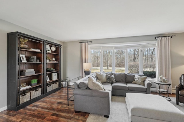 living area with baseboards and dark wood-type flooring