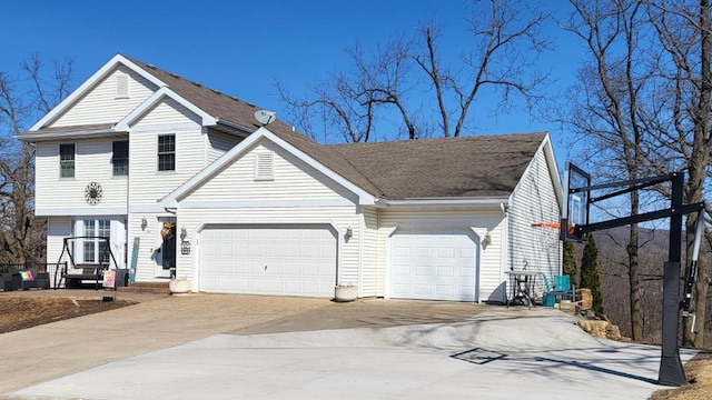 view of front of house featuring a garage, roof with shingles, and concrete driveway