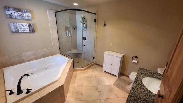 bathroom with a shower stall, a jetted tub, toilet, tile patterned floors, and vanity