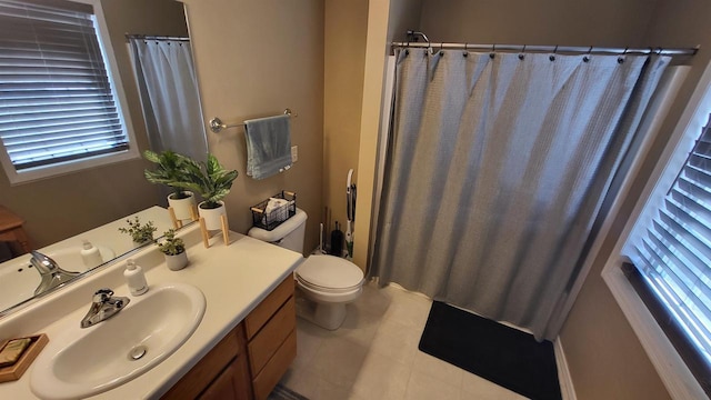 bathroom featuring a shower with shower curtain, toilet, vanity, and tile patterned floors