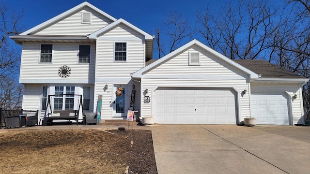 traditional-style home featuring an attached garage and driveway