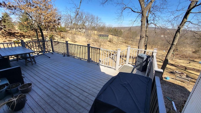 deck with central AC unit and a grill