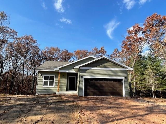 ranch-style house with an attached garage and driveway