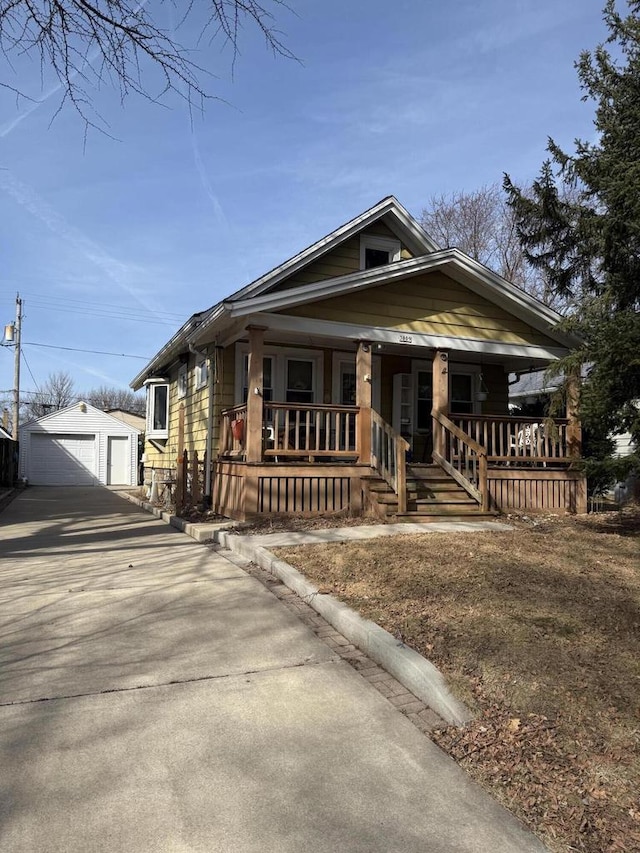 view of front of home featuring an outbuilding, covered porch, and a garage