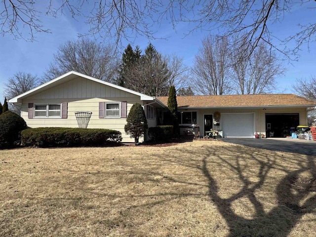 ranch-style house featuring aphalt driveway and an attached garage