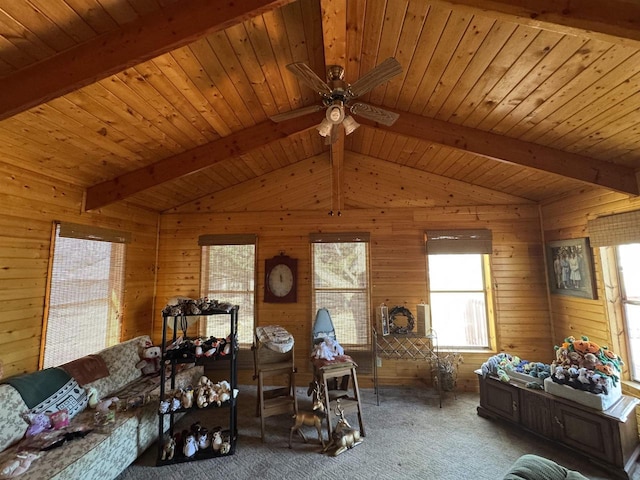 carpeted living area with lofted ceiling with beams, wooden walls, and wood ceiling