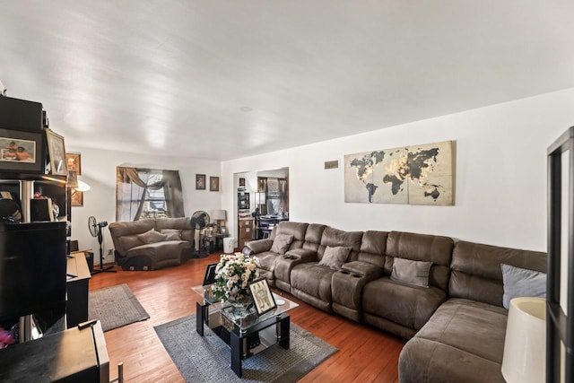 living room featuring visible vents and hardwood / wood-style flooring