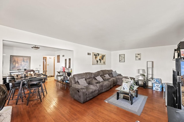 living room with visible vents and wood-type flooring