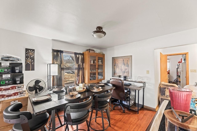 home office with wood finished floors and baseboards