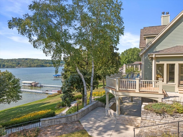 view of patio featuring a deck with water view