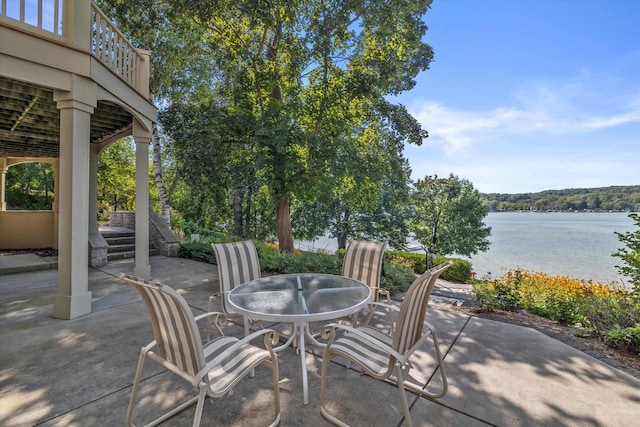 view of patio / terrace with outdoor dining space and a water view