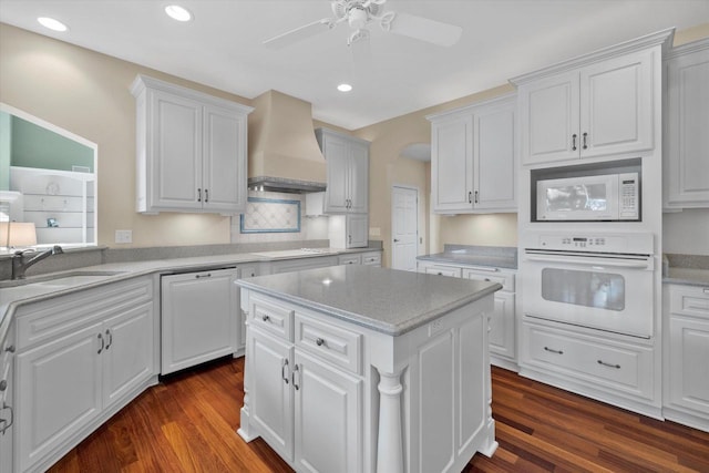 kitchen featuring custom range hood, dark wood-style floors, white appliances, white cabinetry, and a sink