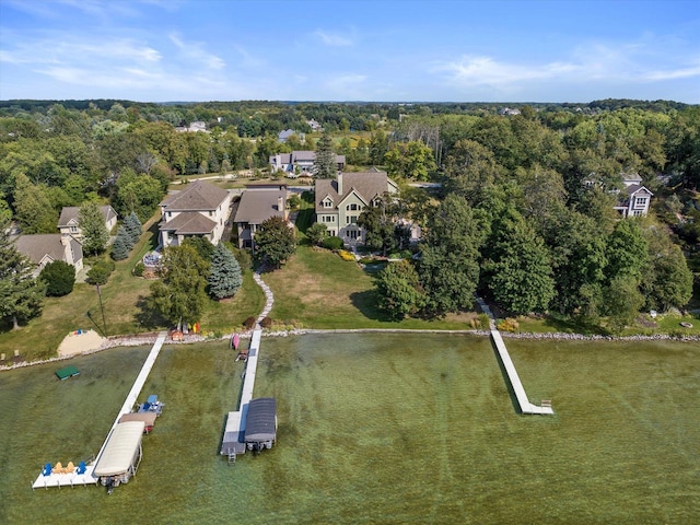 birds eye view of property with a forest view