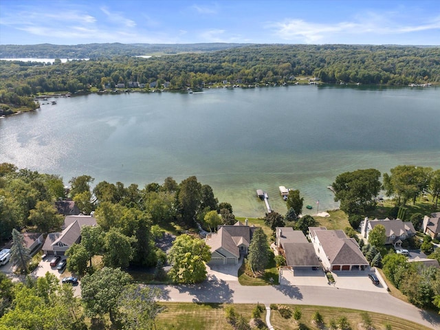 birds eye view of property with a residential view, a view of trees, and a water view