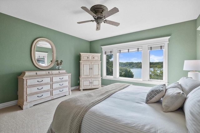 bedroom with light carpet, a ceiling fan, and baseboards