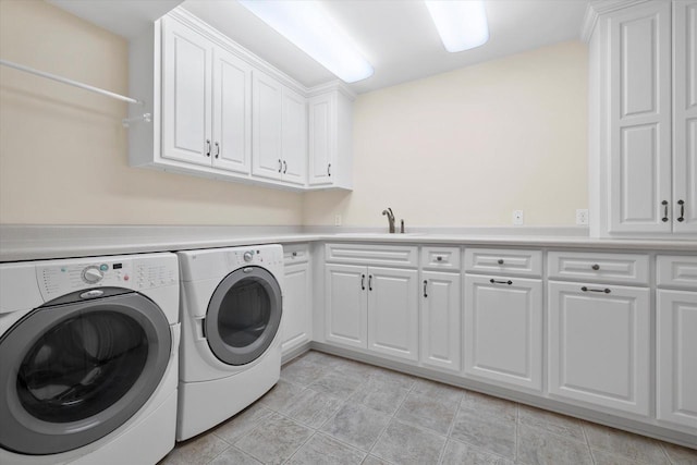 laundry room with washing machine and dryer, light tile patterned floors, cabinet space, and a sink