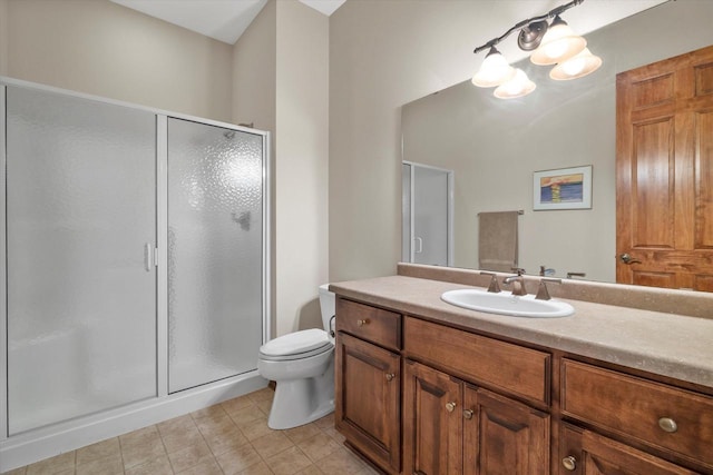 full bathroom featuring toilet, a stall shower, vanity, and tile patterned flooring