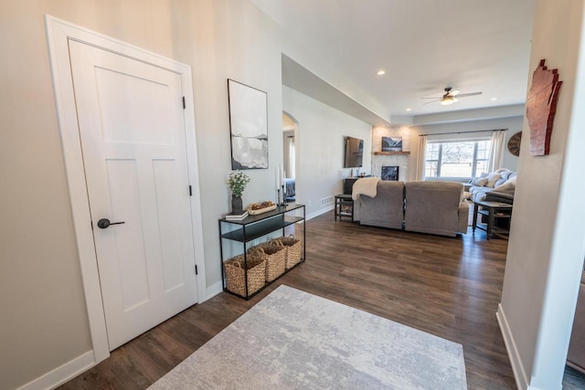 interior space featuring recessed lighting, dark wood-style floors, and baseboards