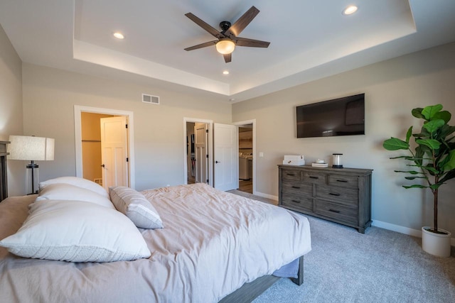 bedroom with visible vents, a raised ceiling, and a walk in closet