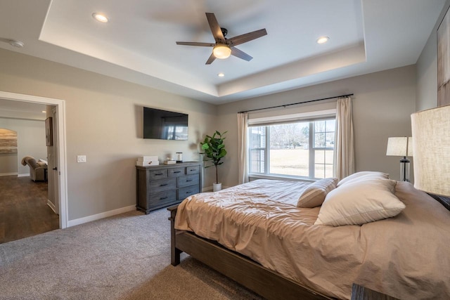 bedroom featuring recessed lighting, baseboards, a raised ceiling, and carpet flooring