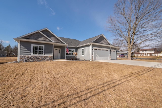 craftsman-style house featuring concrete driveway, an attached garage, stone siding, and a front lawn